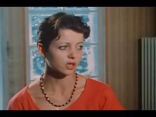 A brunette with small tits fucks two fellows in vintage xxx video