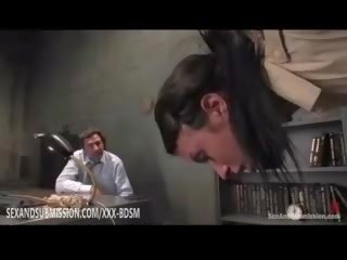 Brunet is tied helplessly from the ceiling