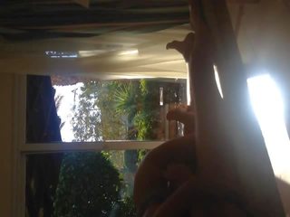 Amateur fucking teen in front of window