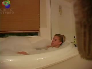 Alluring blond mademoiselle caught playing with herself in the bath