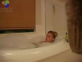 Alluring blond mademoiselle caught playing with herself in the bath