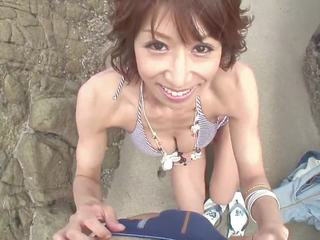 Lascivious brunette sucks guy's pole on the beach
