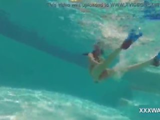 Great brunette escort Candy swims underwater