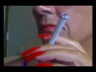 Elegant provocative Smoking with splendid fascinating Red Nails.